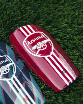 Red Arsenal crest shin pad with white stripes