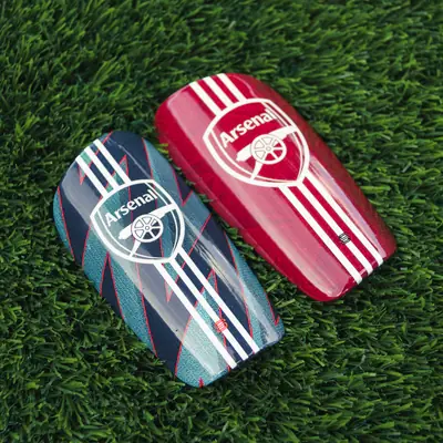 Pair of striped custom shin pads in red and dark green